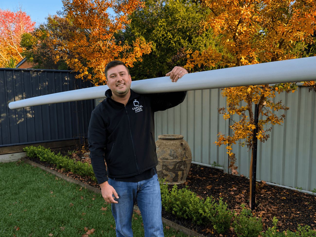 Connor carrying pipe on a Canberra job